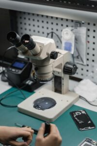 Close-Up Shot of a Person Repairing a Device